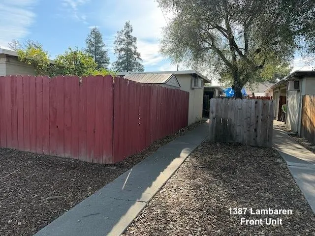 a view of backyard with wooden fence
