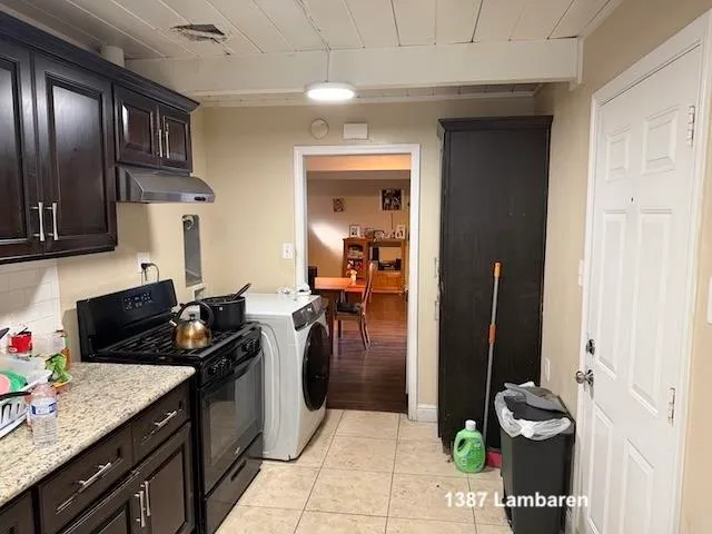 a view of a hallway with wooden floor and stairs