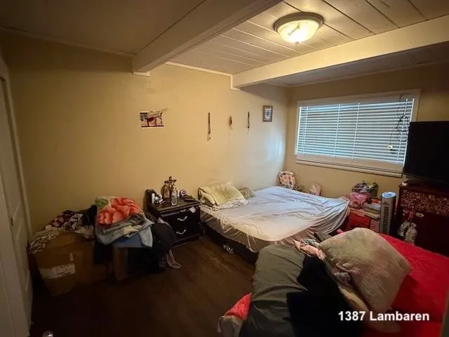 a bed sitting in a bedroom next to a window
