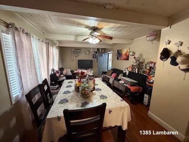 a view of a dining room with furniture and a chandelier fan