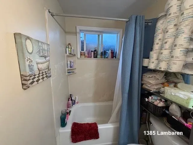 a bathroom with a bathtub and shower