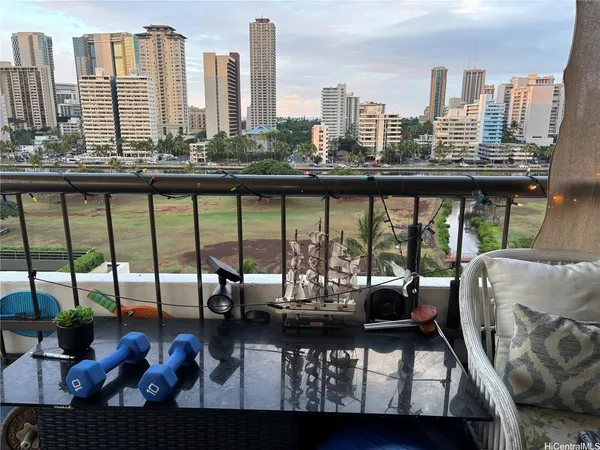 a view of a balcony with two chairs and a table