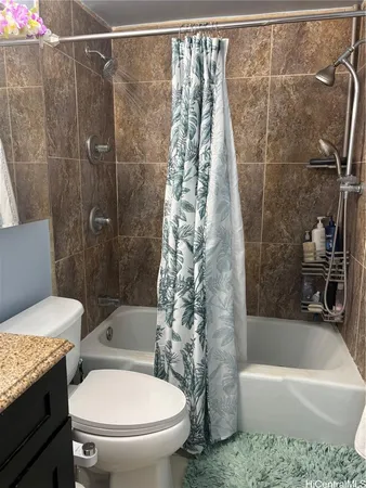 a bathroom with a toilet and a bathtub