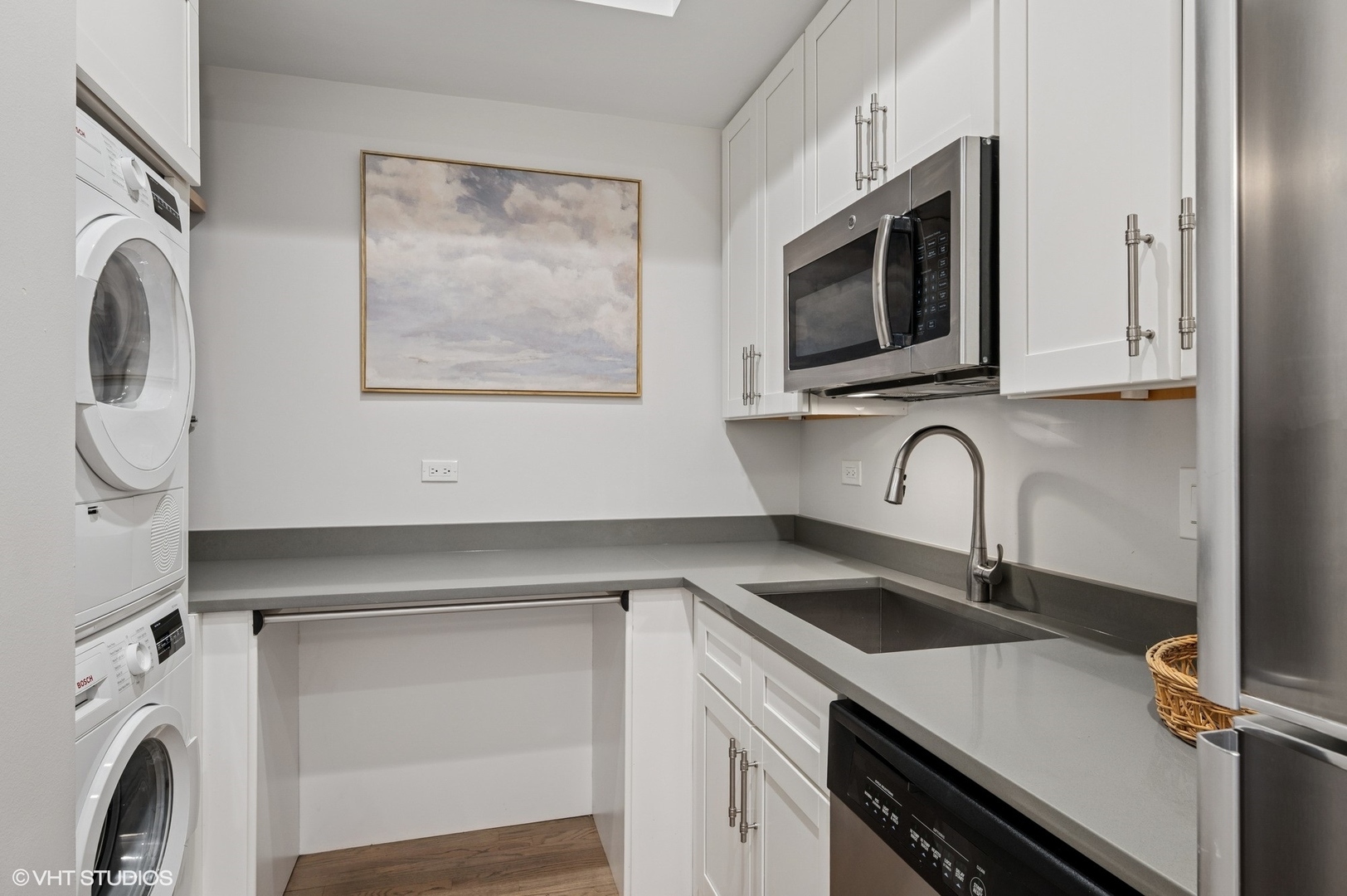 212 West Washington Street, Unit 1807 Chicago, IL 60606 - Photo 16 of 24 a kitchen with stainless steel appliances granite countertop a sink a stove and microwave