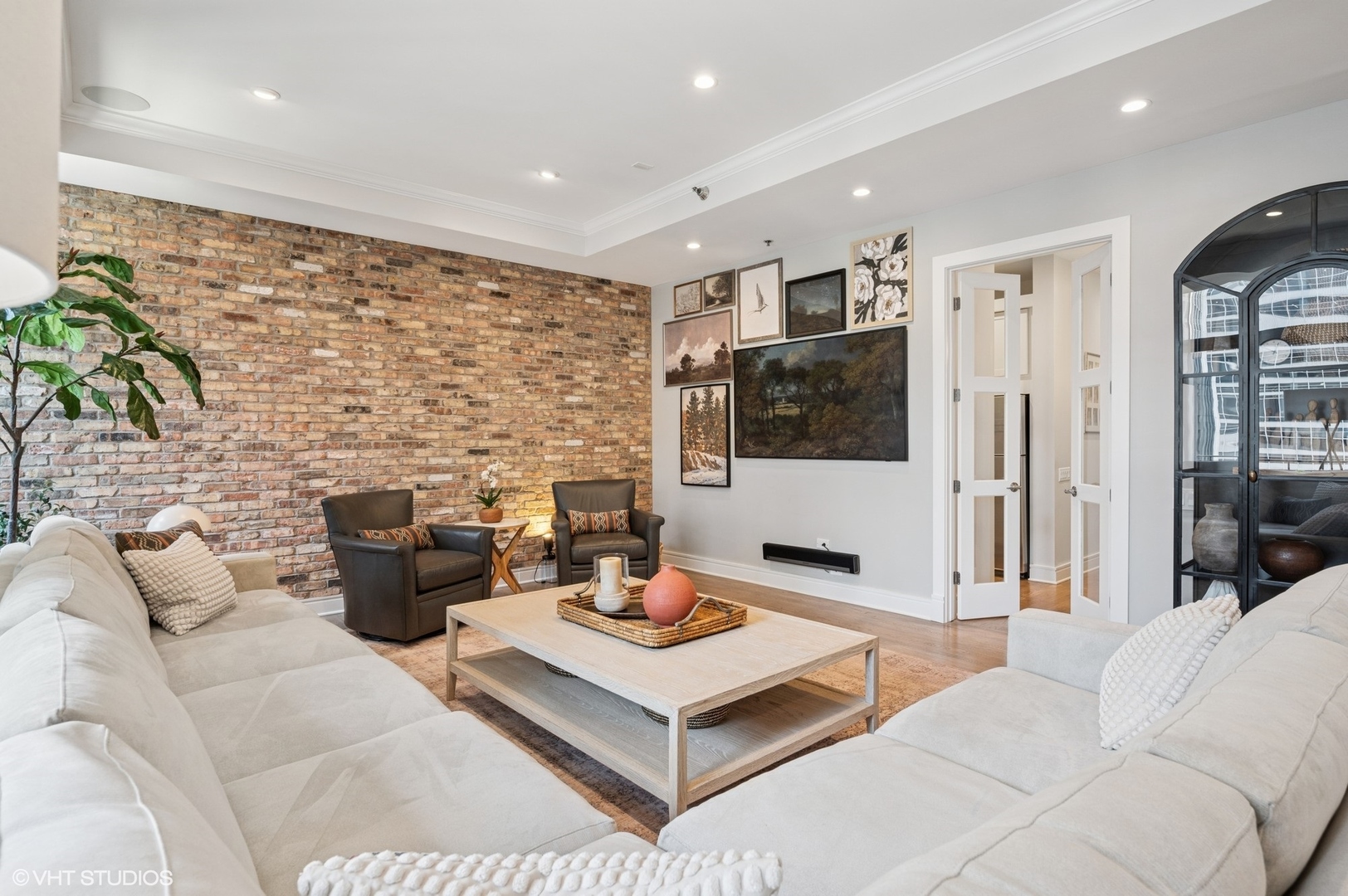 212 West Washington Street, Unit 1807 Chicago, IL 60606 - Photo 7 of 24 a living room with furniture wooden floor and a flat screen tv