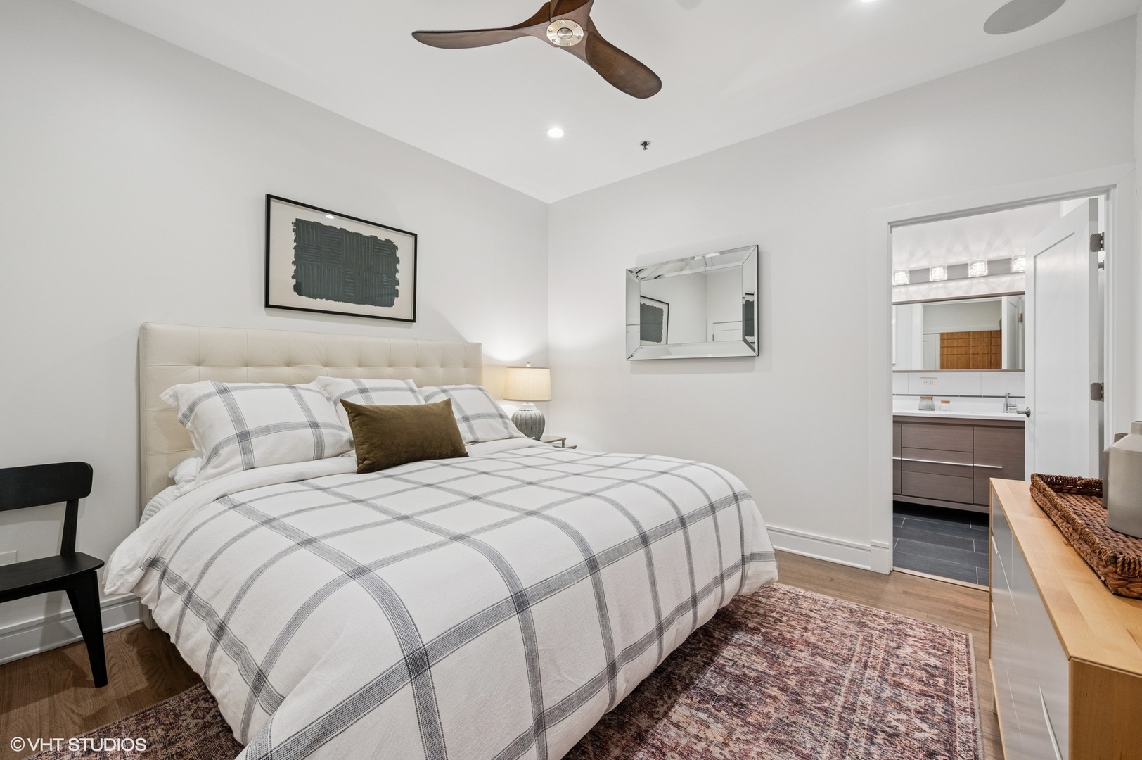 212 West Washington Street, Unit 1807 Chicago, IL 60606 - Photo 8 of 24 a bedroom with bed and a chandelier