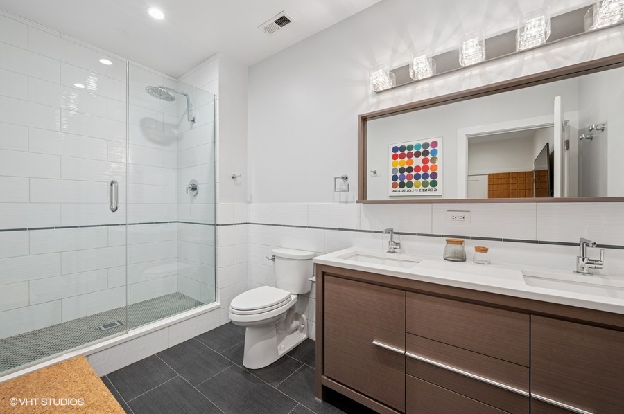 212 West Washington Street, Unit 1807 Chicago, IL 60606 - Photo 9 of 24 a bathroom with a sink a toilet and shower
