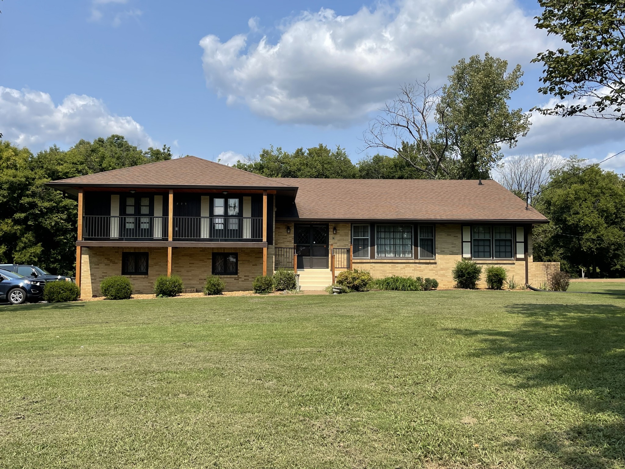 a view of a house with yard and sitting area