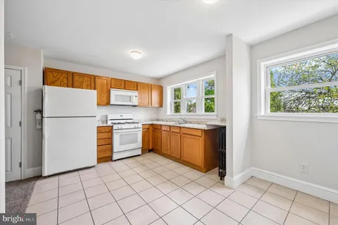 a kitchen with a refrigerator sink and cabinets