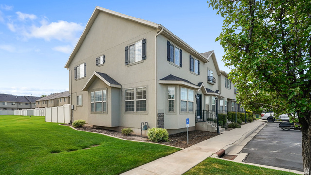 983 South 1850th Street West Springville, UT 84663 - Photo 17 of 30 Townhome exterior with stucco siding, black window shutters, and a bay window feature