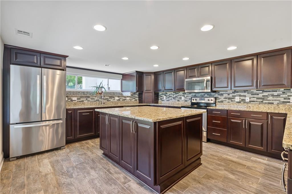 124 McBride Hill Road Butler, PA 16002 - Photo 21 of 41 a kitchen with stainless steel appliances granite countertop a stove a refrigerator and a sink