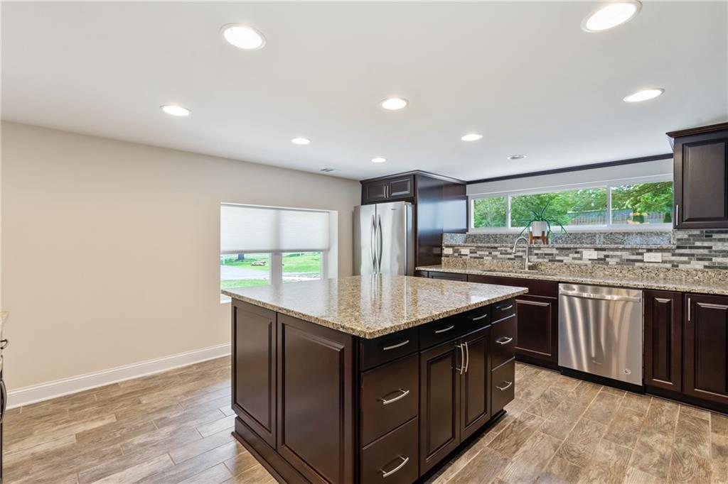 124 McBride Hill Road Butler, PA 16002 - Photo 22 of 41 a kitchen with stainless steel appliances granite countertop a sink and a stove