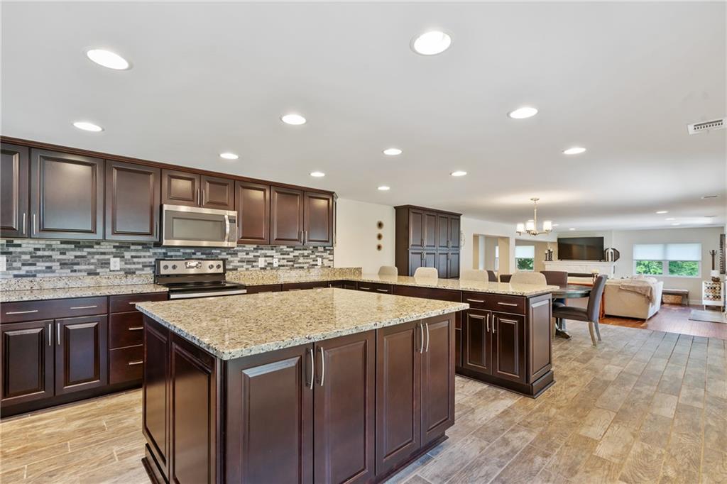 124 McBride Hill Road Butler, PA 16002 - Photo 24 of 41 a kitchen with a stove a sink a counter top space and cabinets