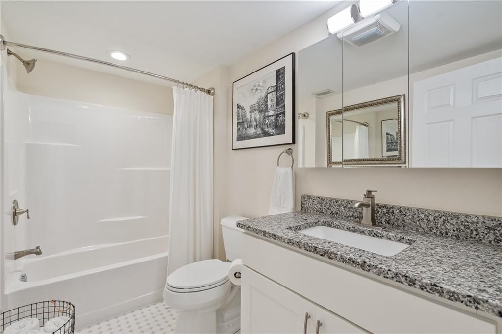 124 McBride Hill Road Butler, PA 16002 - Photo 26 of 41 a bathroom with a granite countertop sink a mirror a toilet and a bathtub
