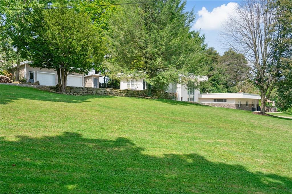 124 McBride Hill Road Butler, PA 16002 - Photo 8 of 41 a view of a house with a big yard and large trees
