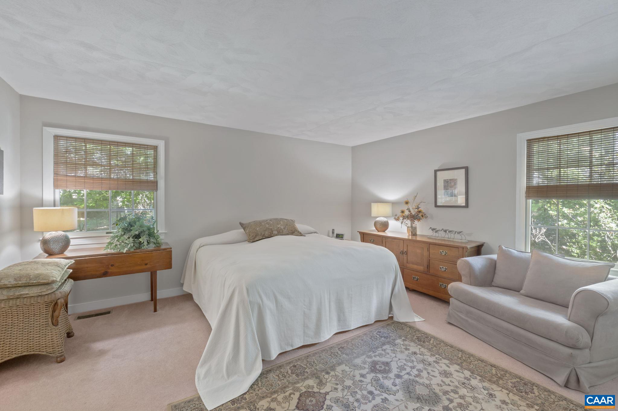 2 Whippoorwill Lane Palmyra, VA 22963 - Photo 16 of 36 a bedroom with a large bed and a couch