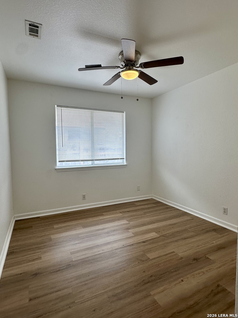 2012 Balsam Way Round Rock, TX 78665 - Photo 11 of 20 a view of an empty room with wooden floor and a window