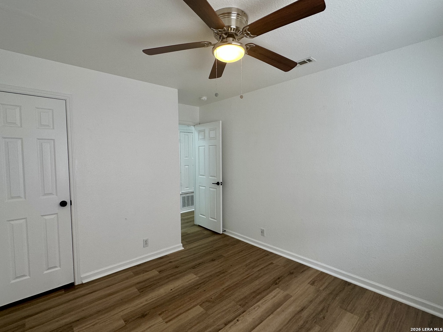 2012 Balsam Way Round Rock, TX 78665 - Photo 15 of 20 an empty room with wooden floor a ceiling fan and closet