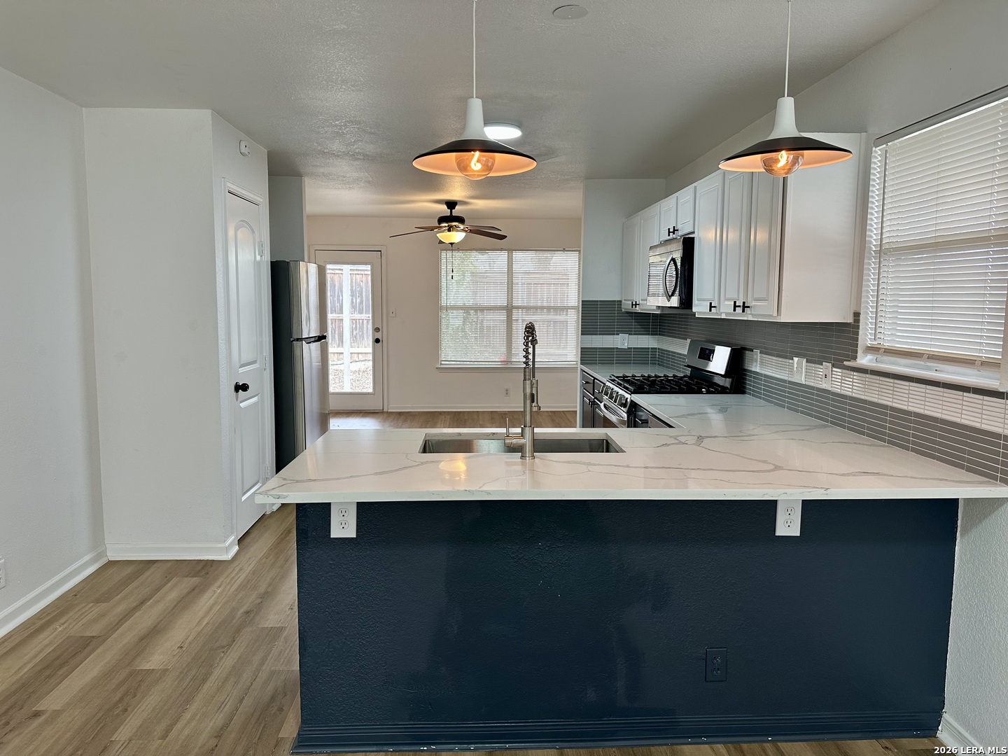 2012 Balsam Way Round Rock, TX 78665 - Photo 8 of 20 a kitchen with kitchen island granite countertop a sink a counter top space and cabinets