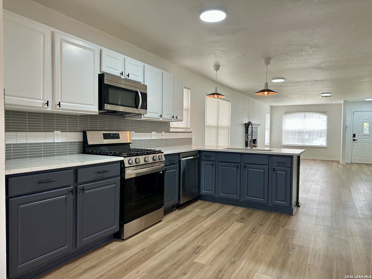 2012 Balsam Way Round Rock, TX 78665 - Photo 9 of 20 a kitchen with stainless steel appliances granite countertop a stove a sink and a microwave