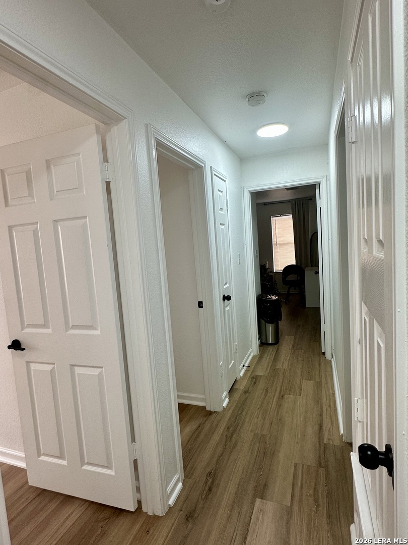2012 Balsam Way Round Rock, TX 78665 - Photo 10 of 20 a view of a hallway with wooden floor and stairs