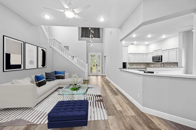 a large kitchen with a large window stainless steel appliances and cabinets