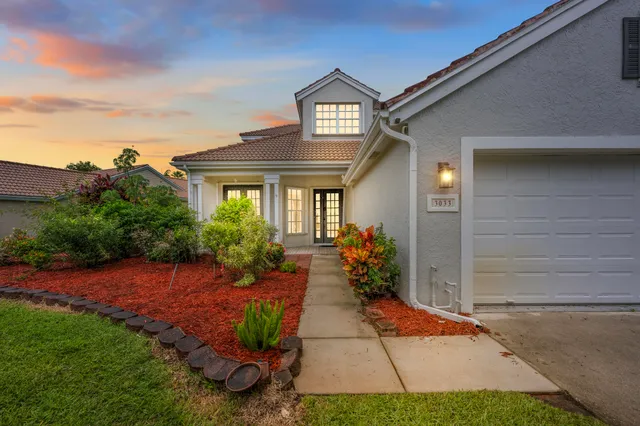 a front view of a house with garden