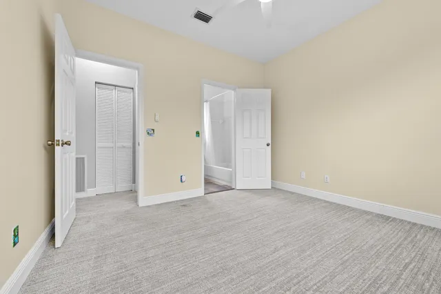 an empty room with wooden floor and window