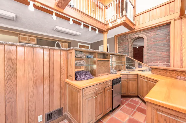 a kitchen with stainless steel appliances granite countertop a stove and a refrigerator