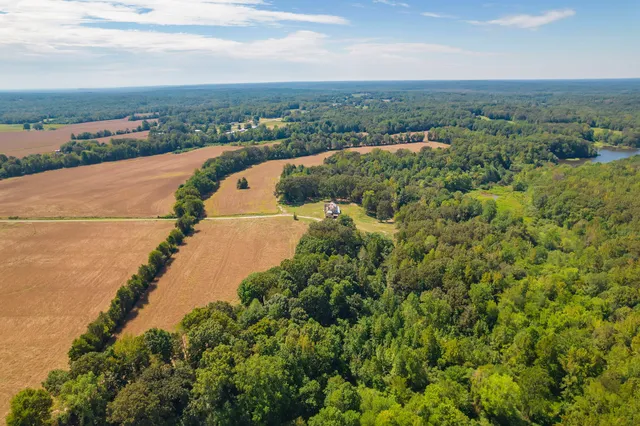 an aerial view of a house with a lake view