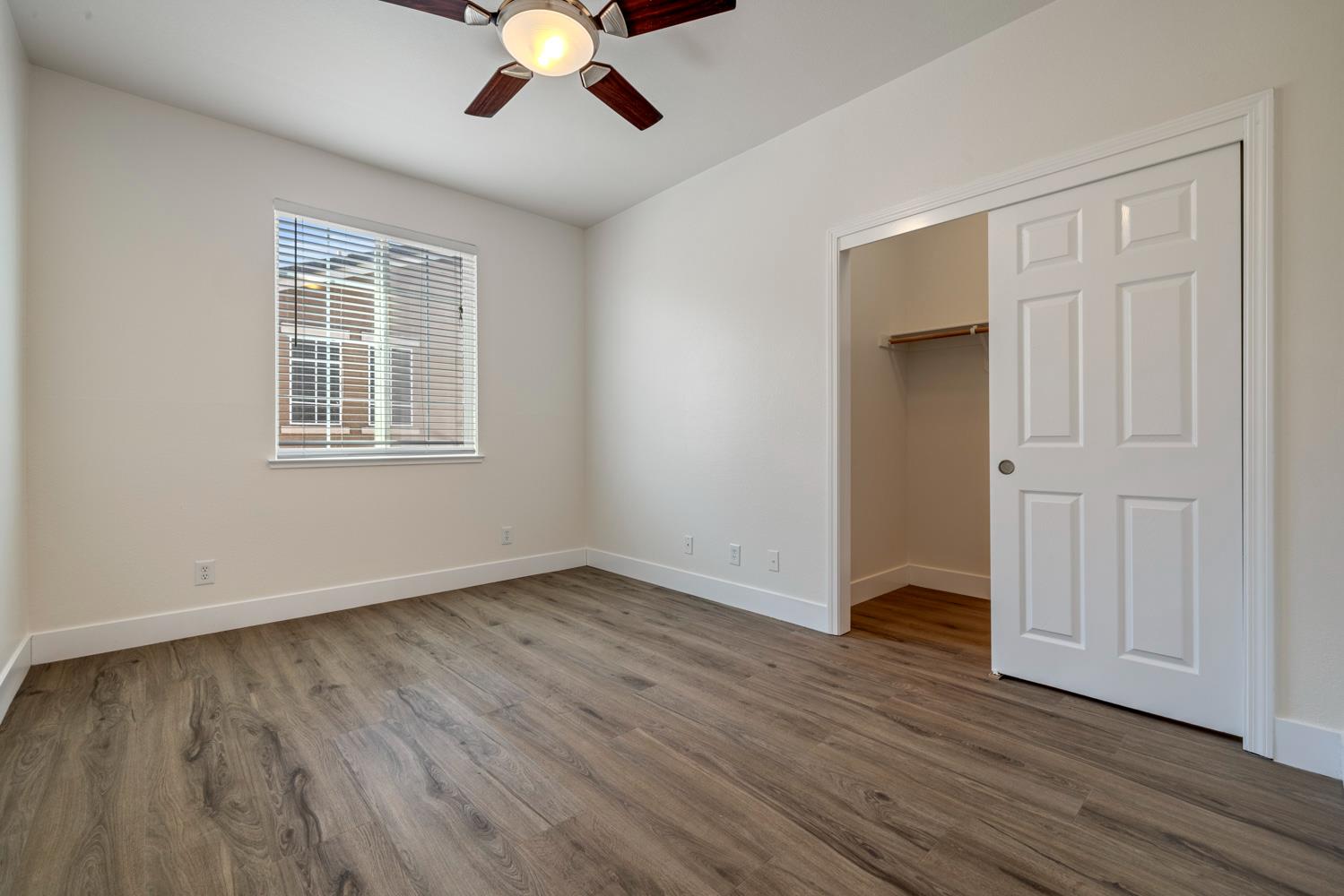 3105 Ripple Court Modesto, CA 95355 - Photo 35 of 46 a view of an empty room with wooden floor and a window