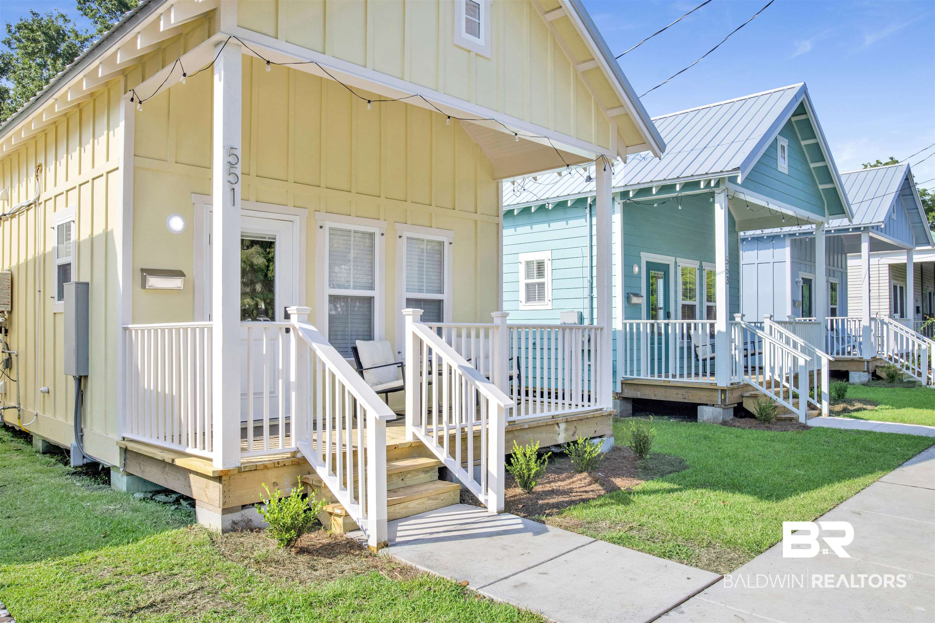 551 Congress Street Mobile, AL 36603 - Photo 4 of 19 View of front of property featuring board and batten siding, a front lawn, a porch, and a metal roof