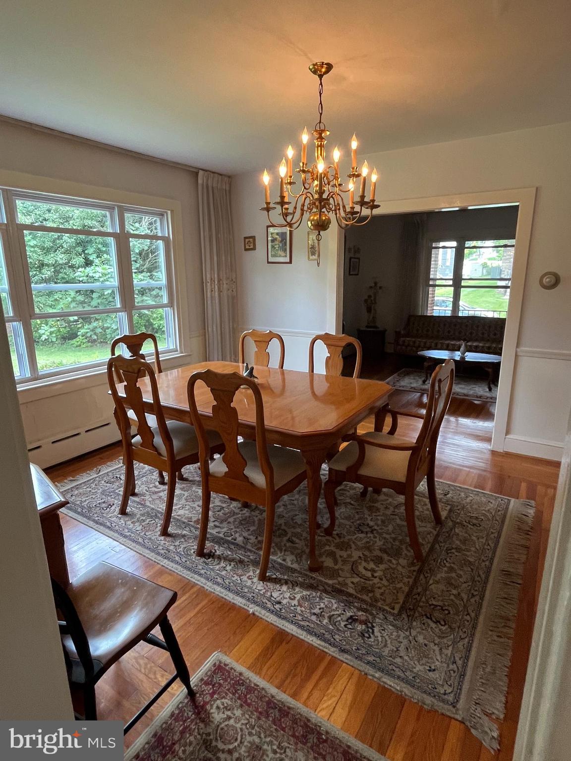 7514 Culp Street Philadelphia, PA 19128 - Photo 11 of 14 a view of a dining room with furniture a chandelier and wooden floor