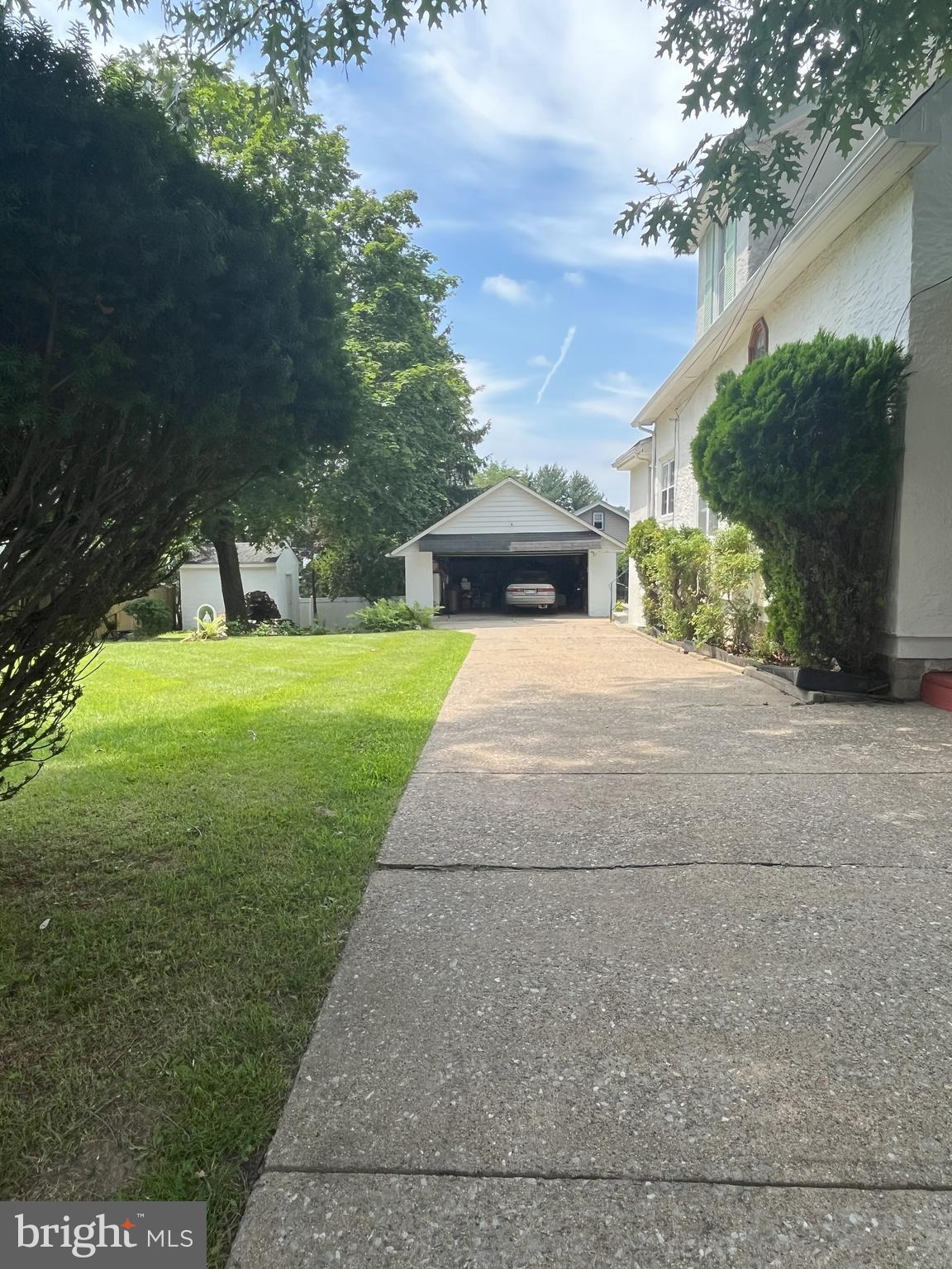 7514 Culp Street Philadelphia, PA 19128 - Photo 5 of 14 a view of a yard with plants and a bench