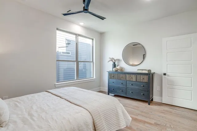 a bedroom with a bed and a night stand