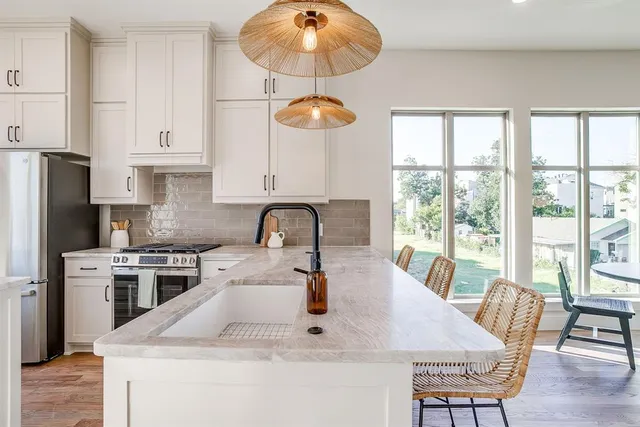 a kitchen with a stove a sink and a refrigerator