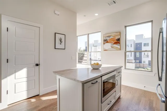 a kitchen with stainless steel appliances granite countertop a stove and a refrigerator