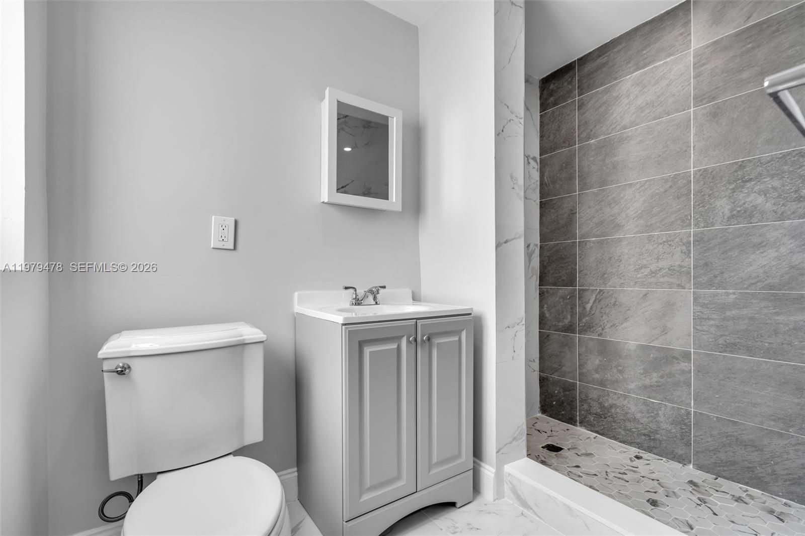 130 Southwest 31st Court, Unit 1 Miami, FL 33135 - Photo 12 of 17 a bathroom with a toilet a sink and shower