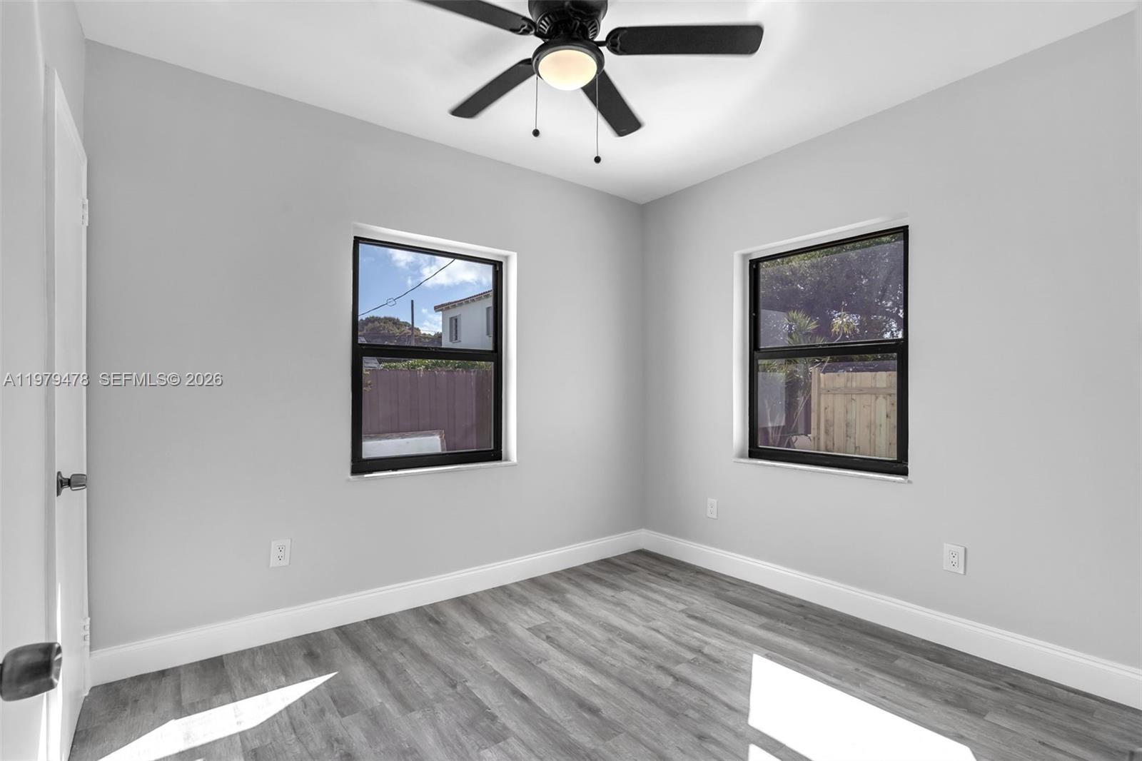 130 Southwest 31st Court, Unit 1 Miami, FL 33135 - Photo 13 of 17 a view of an empty room with window and wooden floor