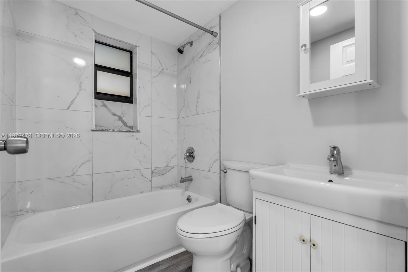 130 Southwest 31st Court, Unit 1 Miami, FL 33135 - Photo 15 of 17 a white bath tub sitting next to a white toilet and sink