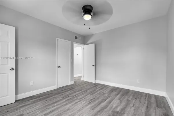 a view of an empty room and wooden floor