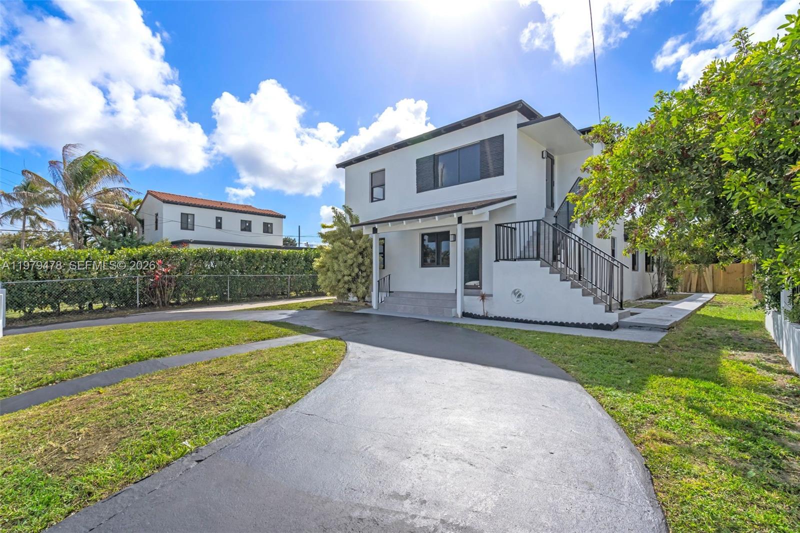130 Southwest 31st Court, Unit 1 Miami, FL 33135 - Photo 2 of 17 a front view of a house with a yard and trees