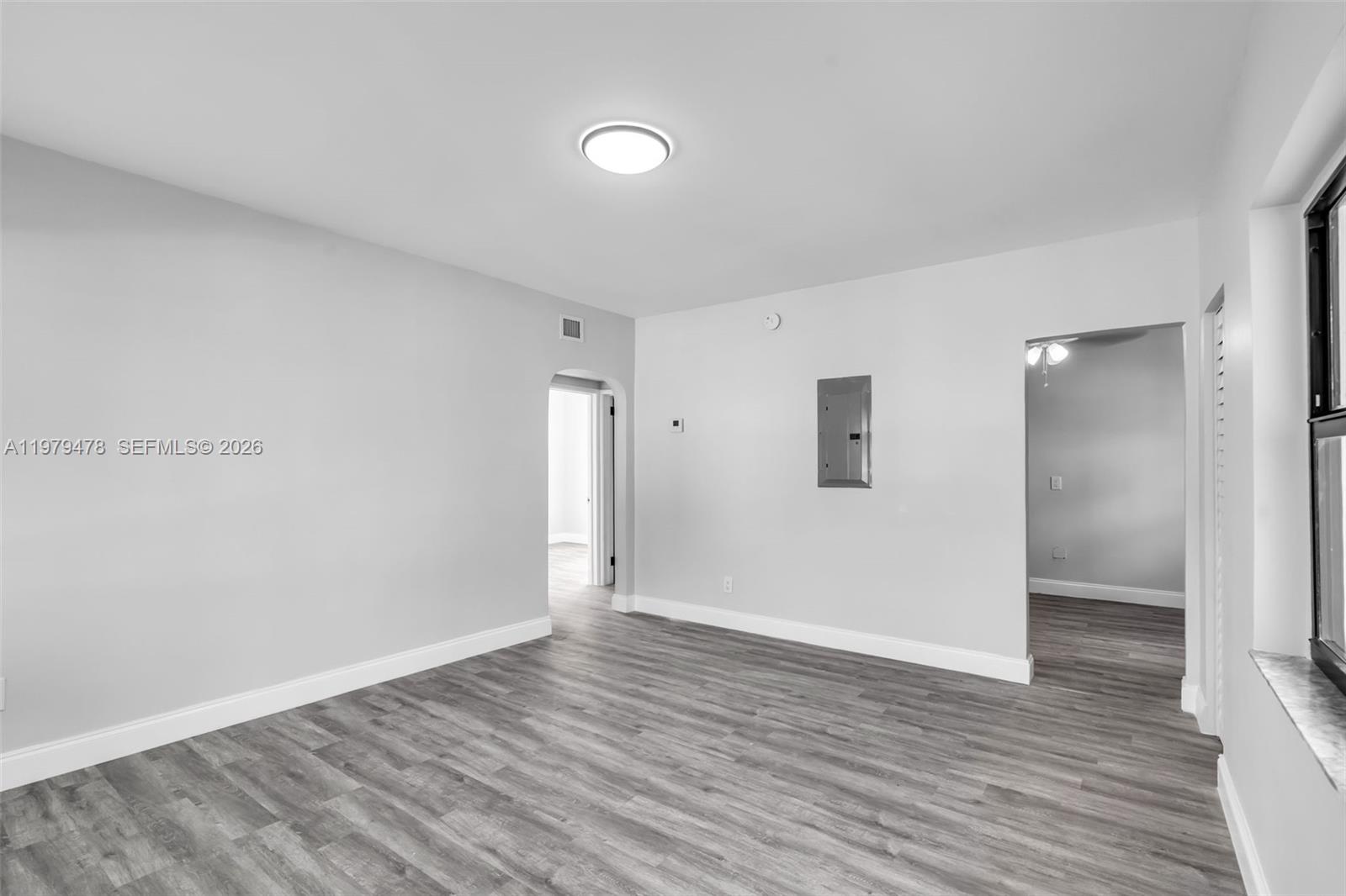 130 Southwest 31st Court, Unit 1 Miami, FL 33135 - Photo 4 of 17 a view of an empty room with wooden floor and closet