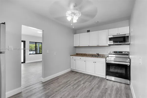 a kitchen with stainless steel appliances granite countertop a stove a sink and a refrigerator