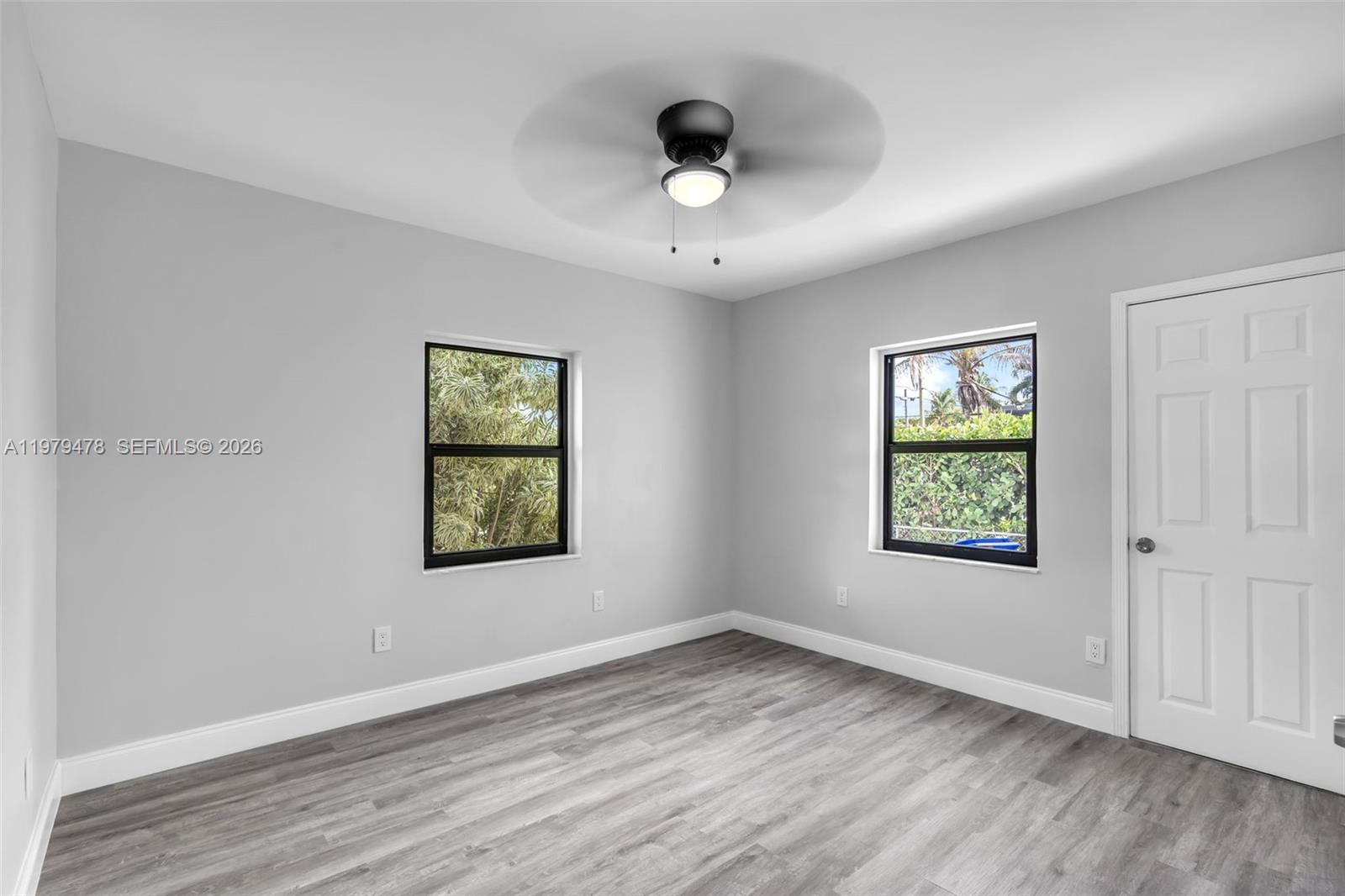 130 Southwest 31st Court, Unit 1 Miami, FL 33135 - Photo 10 of 17 a view of an empty room with wooden floor and a window