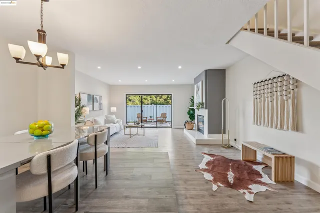 a living room with dining room and wooden floor