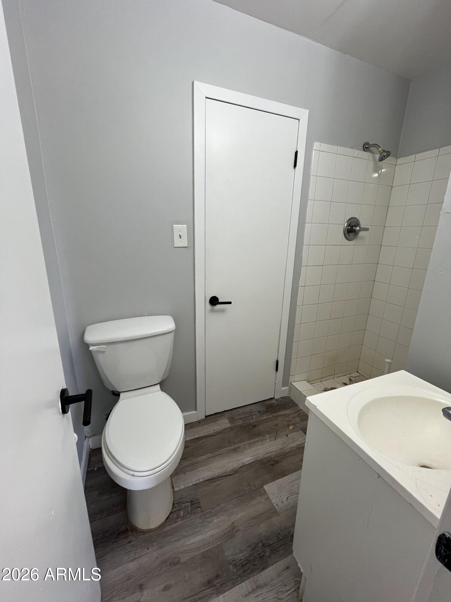 402 North 48th Street Phoenix, AZ 85008 - Photo 4 of 12 a white toilet sitting next to a bathroom sink