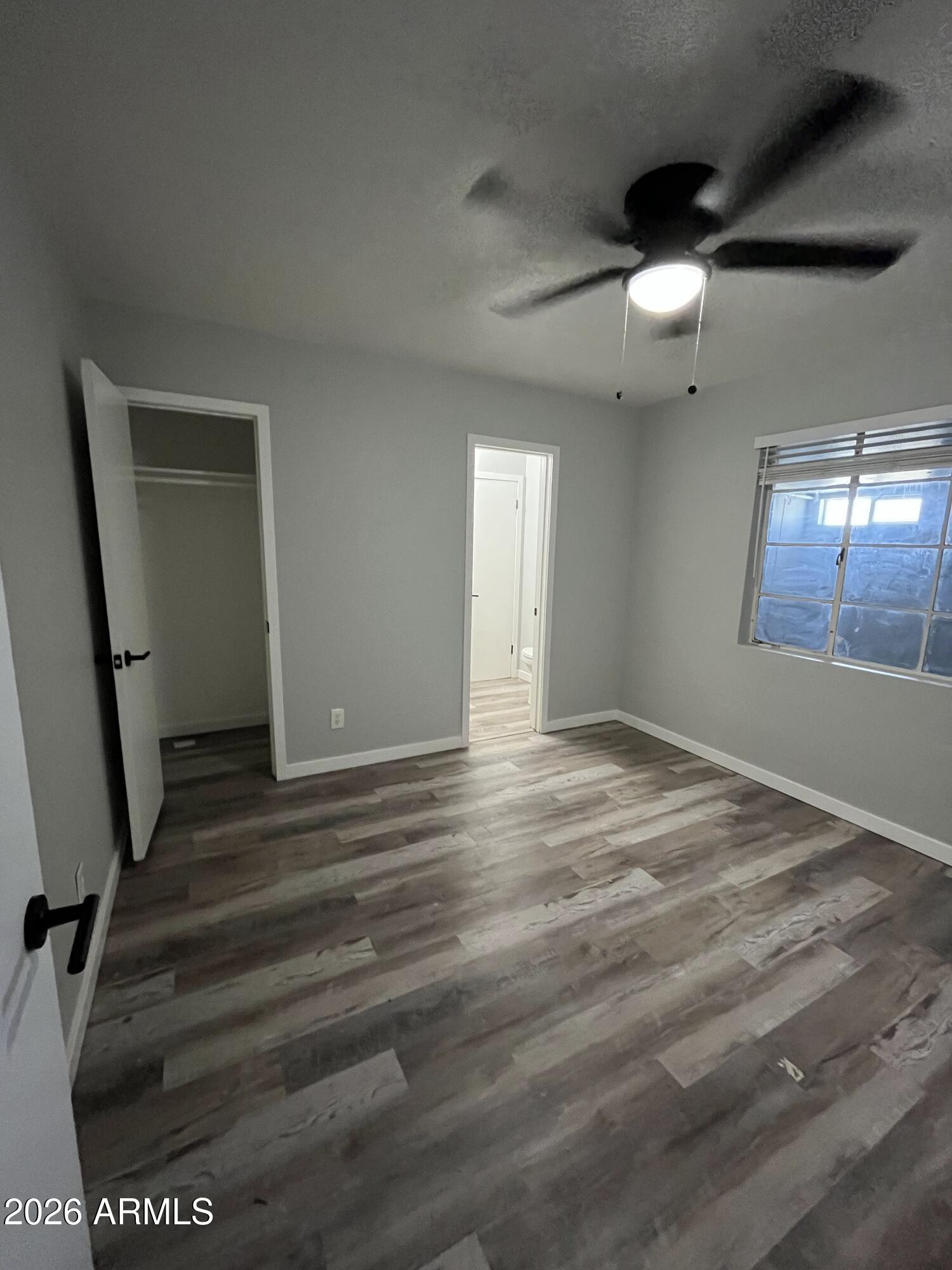 402 North 48th Street Phoenix, AZ 85008 - Photo 8 of 12 an empty room with wooden floor and windows