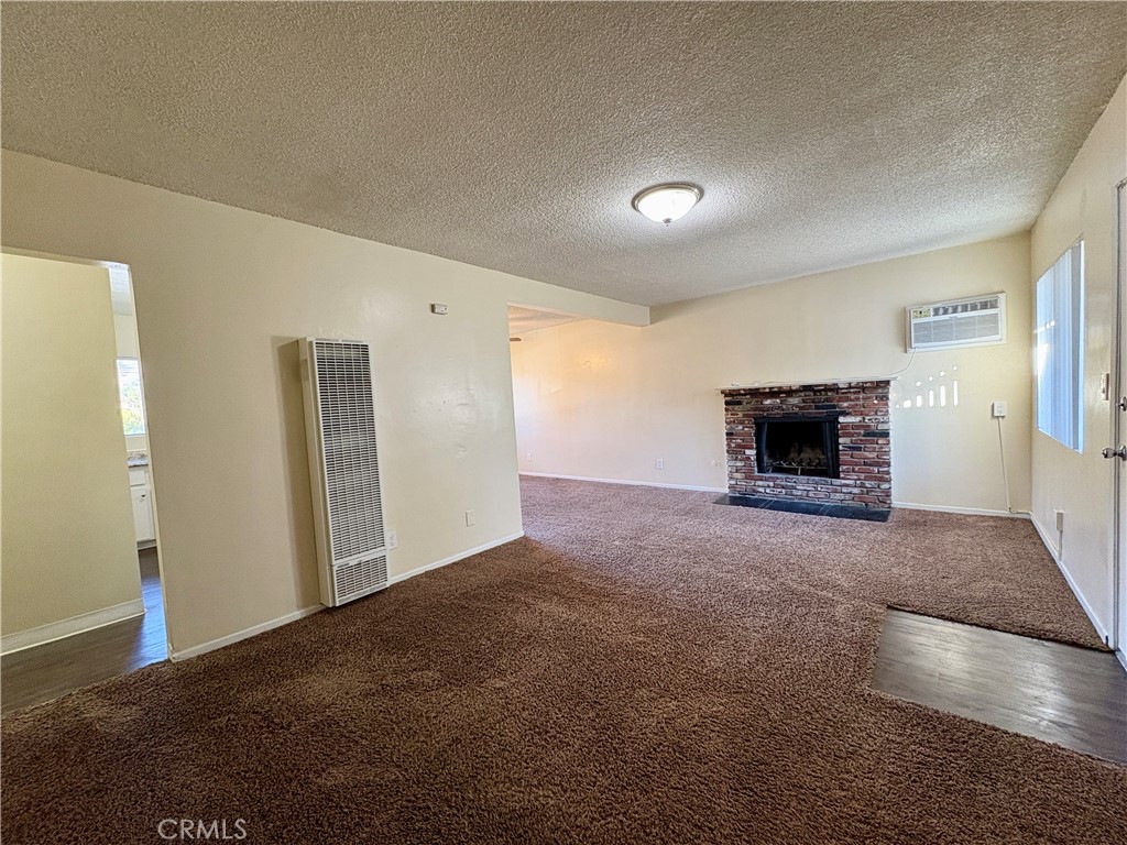 144 West Baseline Road, Unit 7 San Dimas, CA 91773 - Photo 3 of 11 a view of empty room with a fireplace