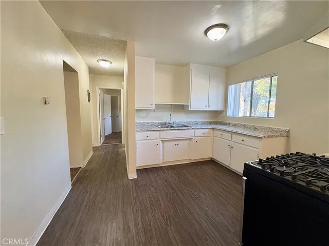 a kitchen with a stove a sink and a refrigerator